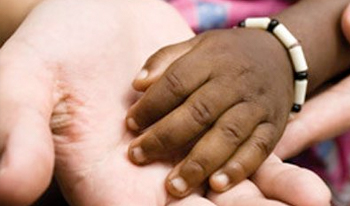 Closeup of a child's hand in an adult's hand