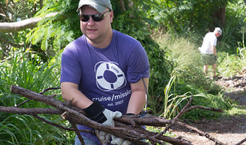 Volunteer carrying sticks and brush